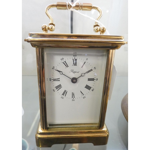 195 - A brass cased carriage clock with eight-day movement, the enamel dial with Roman numerals and inscri... 