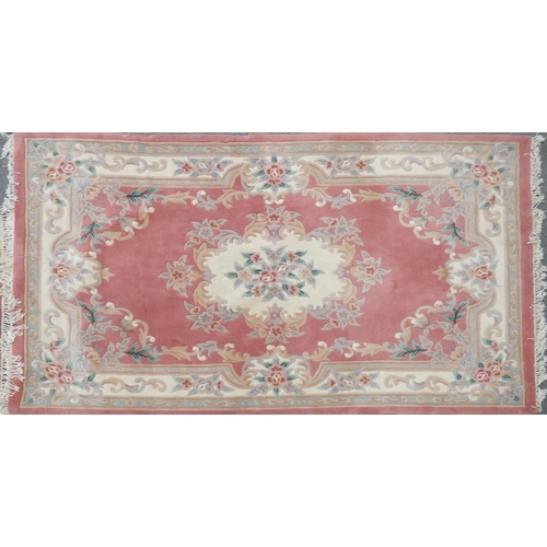 249 - A pink and cream rug, approx 180x280cm and a salmon and cream runner, approx 70x250cm (2)