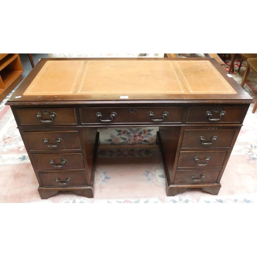 250 - A mahogany twin pedestal desk, inset skiver, central drawer with four drawers to each side