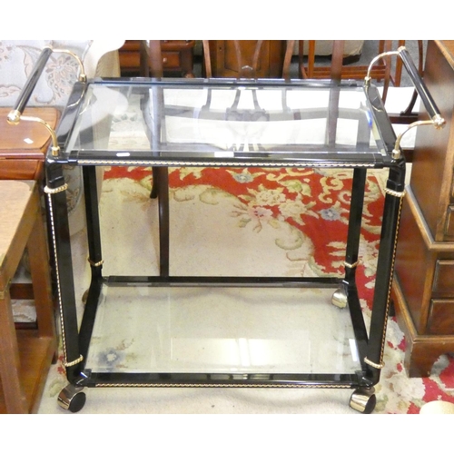 256 - A black metal and gilt framed tea trolley, with glazed top and glazed under tier