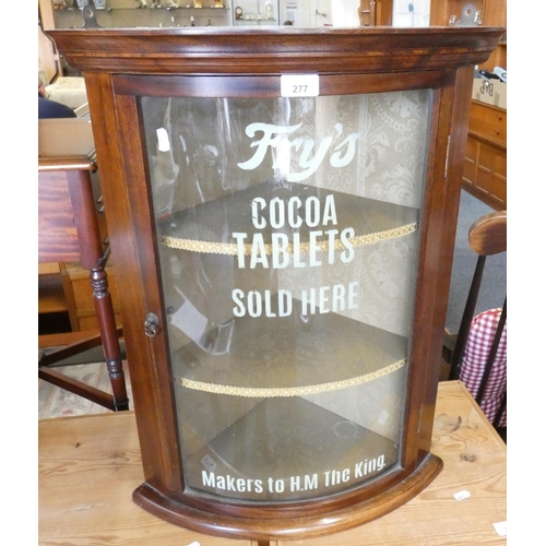 277 - A glazed mahogany corner cupboard, the glass painted Frys Cocoa Tablets Sold Here, height 66cm