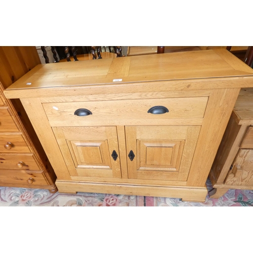 278 - A solid oak side cabinet of panel construction, single frieze drawer over two cupboard doors, 108x39... 