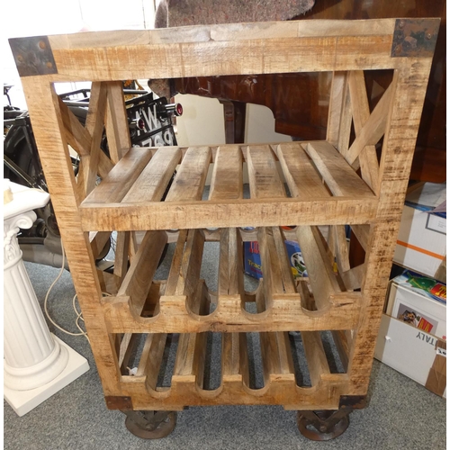 281 - An Industrial style island center table with two wine racks raised on iron wheels, 59x41x89cm