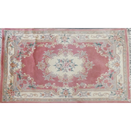 283 - A pair of famile rose Chinese rugs, with tassel ends, 270x185cm and a similar lighter example (3)