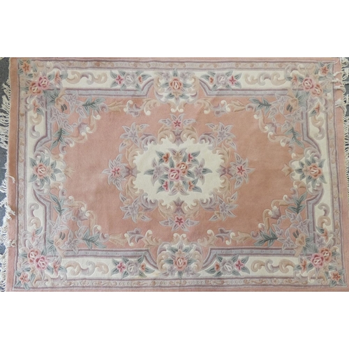 283 - A pair of famile rose Chinese rugs, with tassel ends, 270x185cm and a similar lighter example (3)