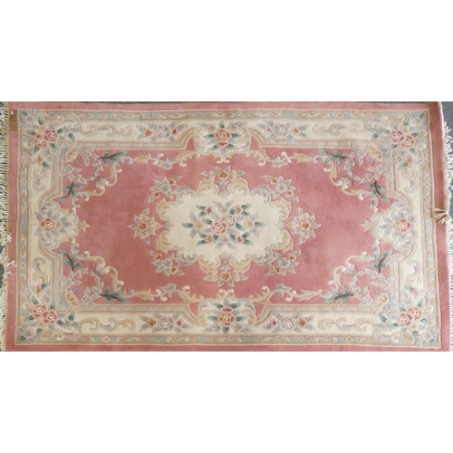 283 - A pair of famile rose Chinese rugs, with tassel ends, 270x185cm and a similar lighter example (3)