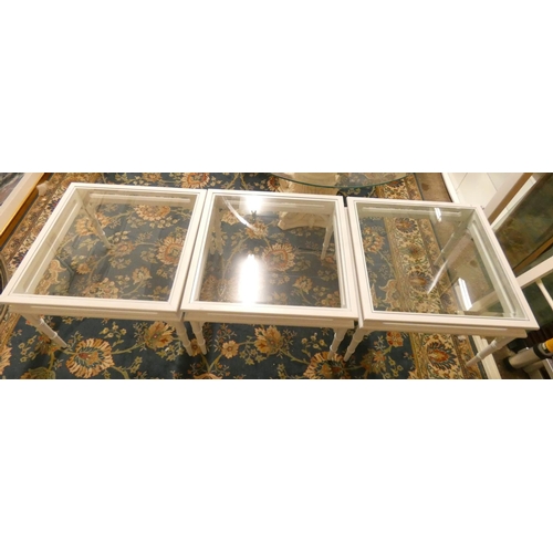 284 - A set of three white painted and bevel edge glass square occasional tables, 69x69x51cm