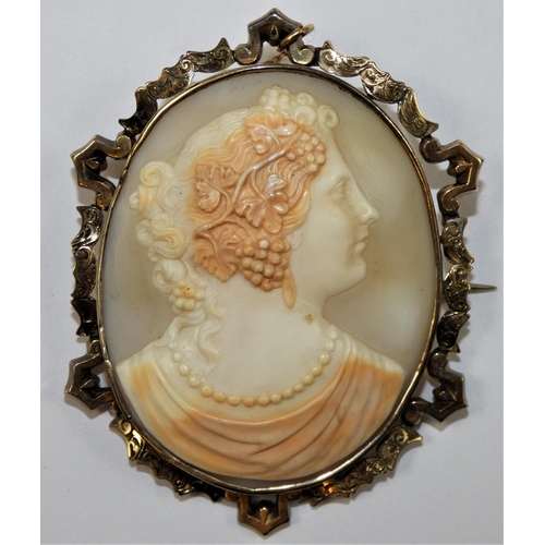 97 - A Victorian gold mounted Bacchanalian lady, with pearl necklace, within a scroll frame, 7 x 5.5 cm.