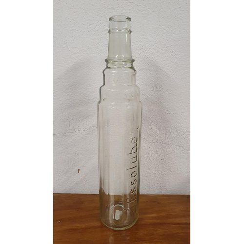 85 - A clear glass Essolube 1 quart oil bottle, 39 cm.