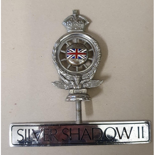 73 - An RAC enamel bumper badge, numbered MCB20102 and a Rolls Royce Silver Shadow II badge (2).