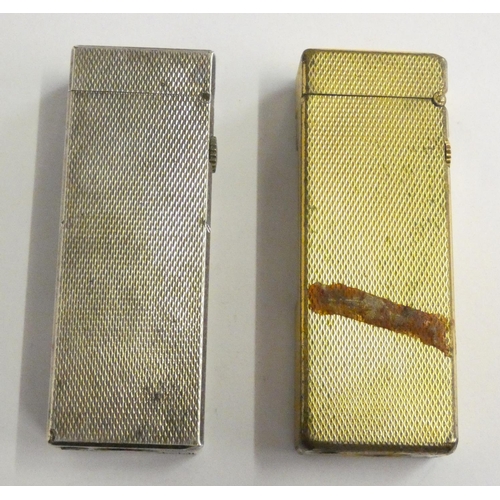 144 - A Dunhill 70 cigarette lighter, case, paperwork, another cased Dunhill lighter and a third, uncased.