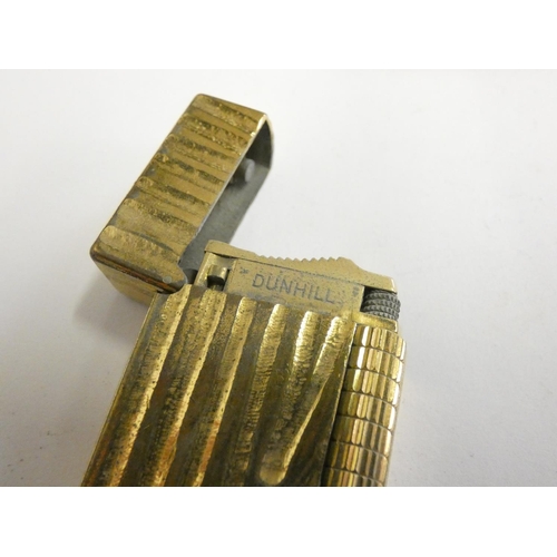 144 - A Dunhill 70 cigarette lighter, case, paperwork, another cased Dunhill lighter and a third, uncased.