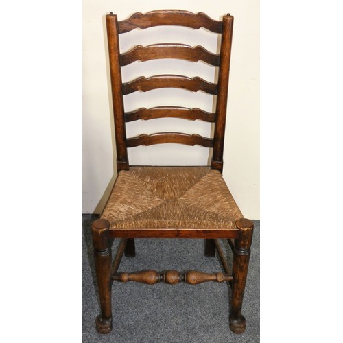 450 - A George III set of six Lancashire style oak wavy ladder back dining chairs, two carvers and four ch... 