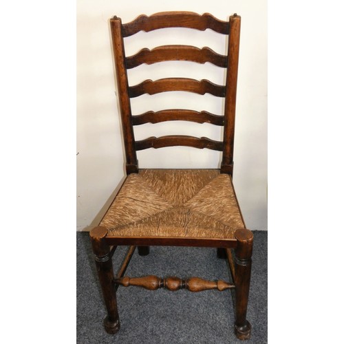 450 - A George III set of six Lancashire style oak wavy ladder back dining chairs, two carvers and four ch... 