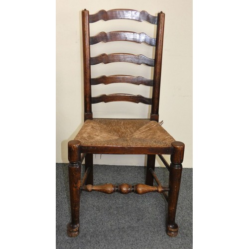 450 - A George III set of six Lancashire style oak wavy ladder back dining chairs, two carvers and four ch... 