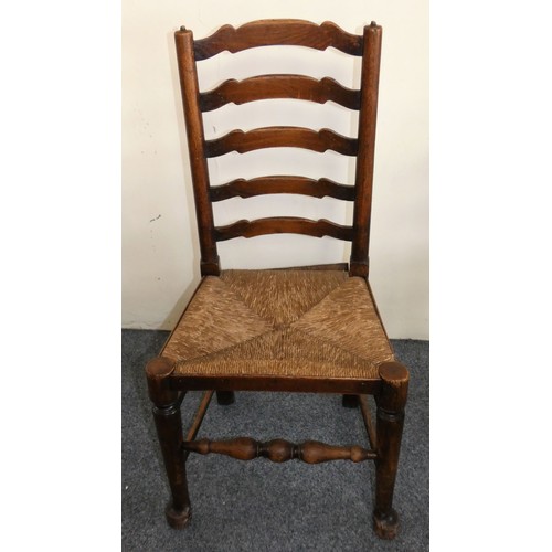 450 - A George III set of six Lancashire style oak wavy ladder back dining chairs, two carvers and four ch... 