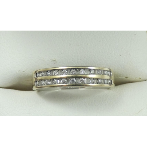 83 - An 18ct white gold and diamond eternity ring, channel set with a double row of brilliant cut stones,... 