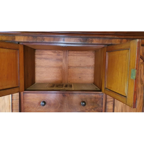 464 - A 19th century mahogany wardrobe, the central cupboard over four graduated drawers, the right cupboa... 