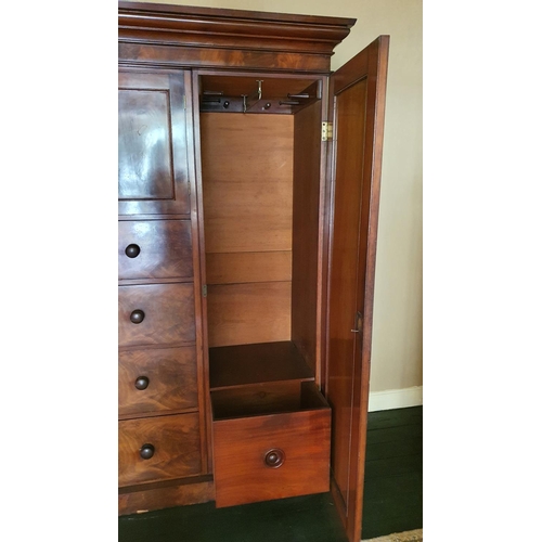 464 - A 19th century mahogany wardrobe, the central cupboard over four graduated drawers, the right cupboa... 