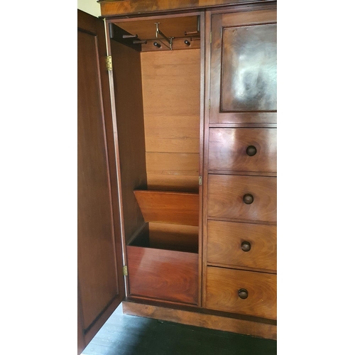 464 - A 19th century mahogany wardrobe, the central cupboard over four graduated drawers, the right cupboa... 