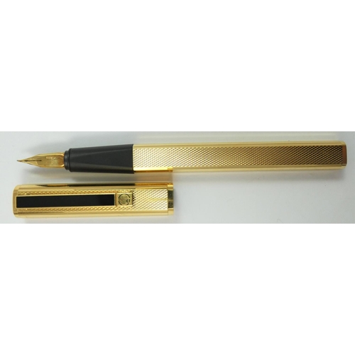 79 - Dunhill, a gilt metal Gemline fountain pen, with engine turned body, 18K gold knib, warranty card, b... 