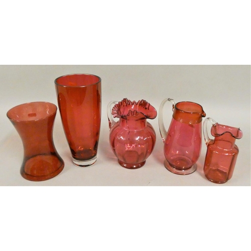 305 - Five pieces of Victorian Cranberry glassware, to include three jugs, a trumpet vase and another vase... 