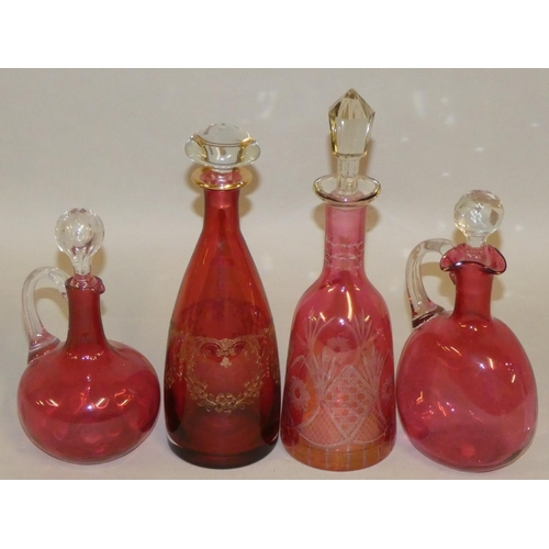 306 - A group of four Victorian Cranberry glass decanters, all with stoppers, tallest 34cm (4).