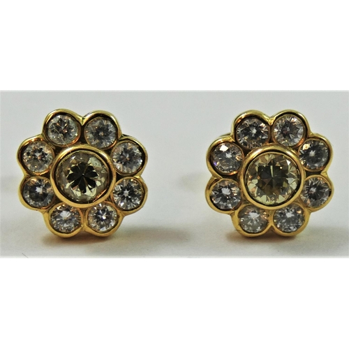 114 - A pair of yellow gold , fancy yellow and white diamond cluster earstuds, the central stone of good c... 