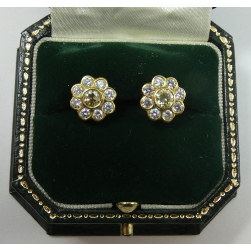 114 - A pair of yellow gold , fancy yellow and white diamond cluster earstuds, the central stone of good c... 