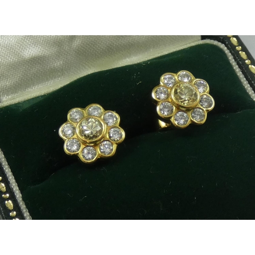 114 - A pair of yellow gold , fancy yellow and white diamond cluster earstuds, the central stone of good c... 