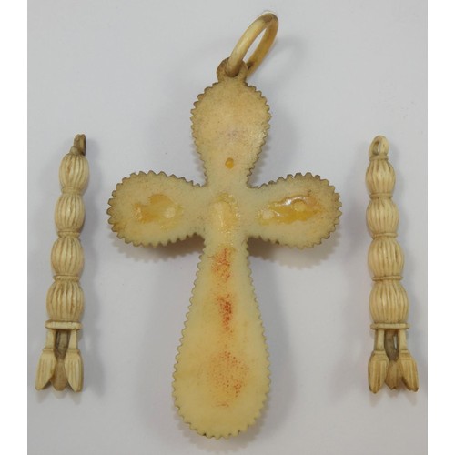 116A - A Victorian carved ivory cross, decorated with roses, length 9 cm, together with a pair of carved iv... 