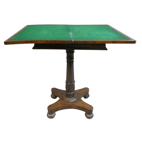 471 - A Regency rosewood fold over games table, the swivel top opening to reveal a baize cover, raised on ... 