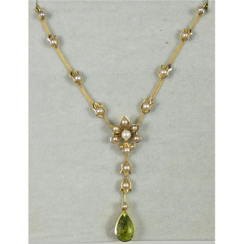 115 - A Victorian peridot and pearl necklace, c. 1880, the pear shape drop suspended from a natural and ha... 