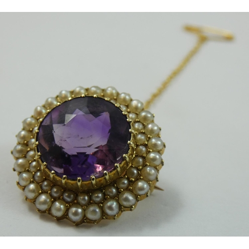 117 - A Victorian gold amethyst and pearl cluster brooch, the circular mixed cut stone bordered by two row... 