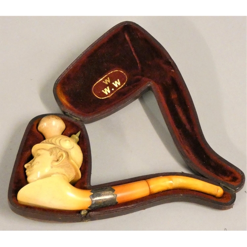 234 - A meerschaum pipe, carved to depict Kaiser Wilhelm II with helmet, silver mount, amber pipe repaired... 