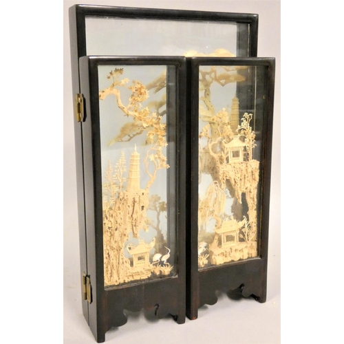 366 - A Chinese carved wood triptych, depicting pagodas, storks and trees, glazed panels, height 25 cm.