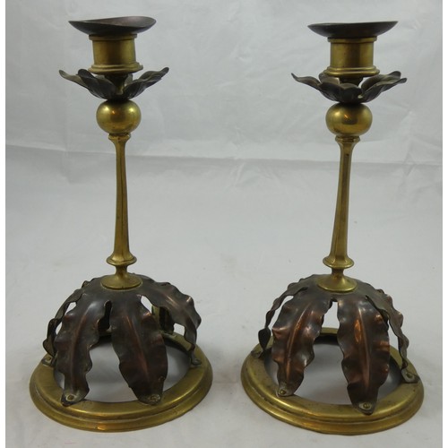 204 - A pair of Arts & Craft copper and brass candlesticks, possibly by W.A.S. Benson, raised on circular ... 