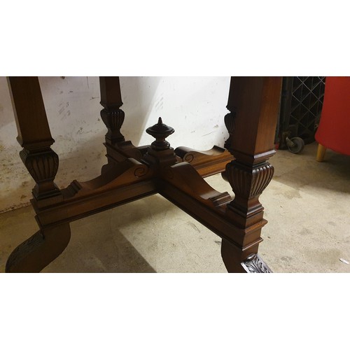 490 - An Edwardian mahogany octagonal dining table, raised on four tapering supports with carved terminals... 