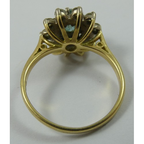 135 - A blue zircon and diamond cluster ring, claw set with a brilliant cut stone, bordered by ten brillia... 