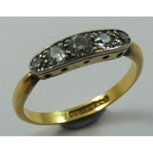 148 - An Edwardian 18 ct gold and diamond five stone ring, channel set with graduated old cut brilliants, ... 