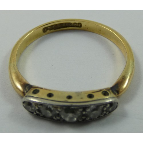 148 - An Edwardian 18 ct gold and diamond five stone ring, channel set with graduated old cut brilliants, ... 