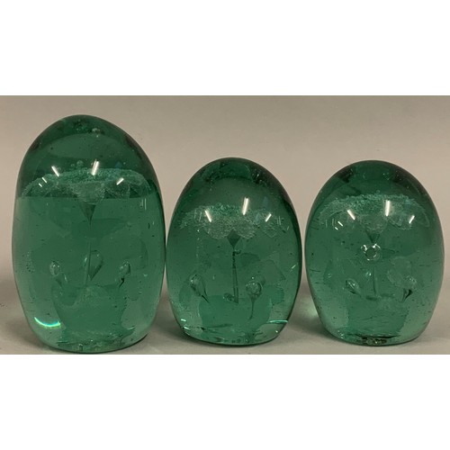 301 - Three Victorian glass dump paperweights, each with internal flower inclusion (3).