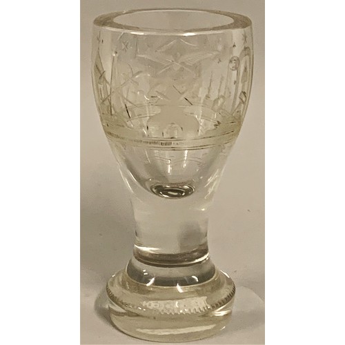 308 - A Victorian Masonic firing glass, engraved with Masonic symbols on a bulbous foot, 14 cm