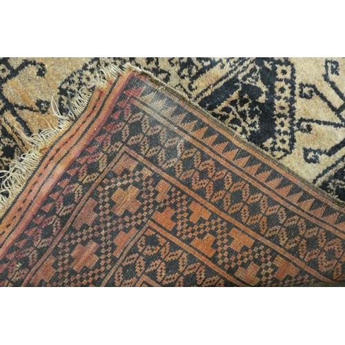 187 - A Turkoman Saryk rug, with vertical gul design, with smaller gul between, 295 x 223 cm.