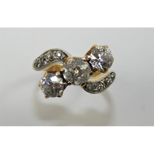 92 - A three stone diamond ring, claw set with an old cut stone, estimated to weigh 0.75 cts, colour esti... 