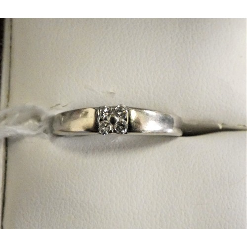 124 - An 18ct white gold and diamond dress ring, (hallmark erased), set with four brilliant cut stones, si... 