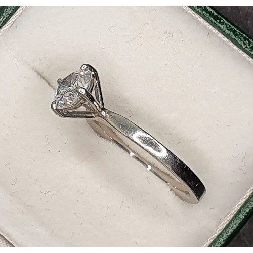 127 - A platinum and diamond single stone diamond ring, four claw set with a brilliant cut stone weighing ... 