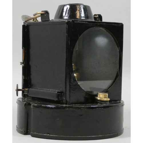 251 - A round based black painted signal lamp with burner.