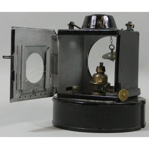 251 - A round based black painted signal lamp with burner.