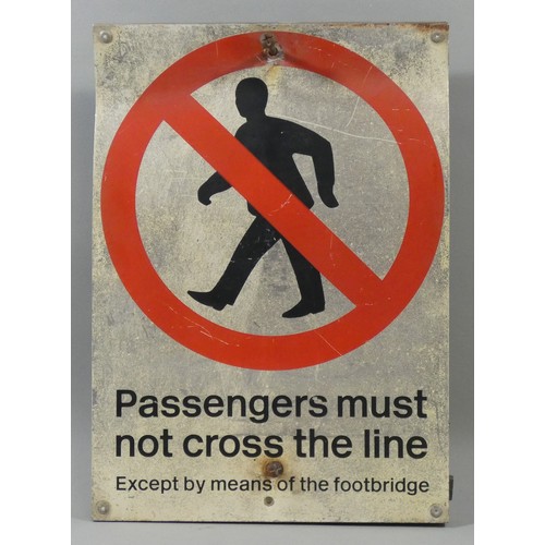 297 - A printed metal sign, Passangers must not cross the line, with pole mounted brackets, 42 x 30 cm.